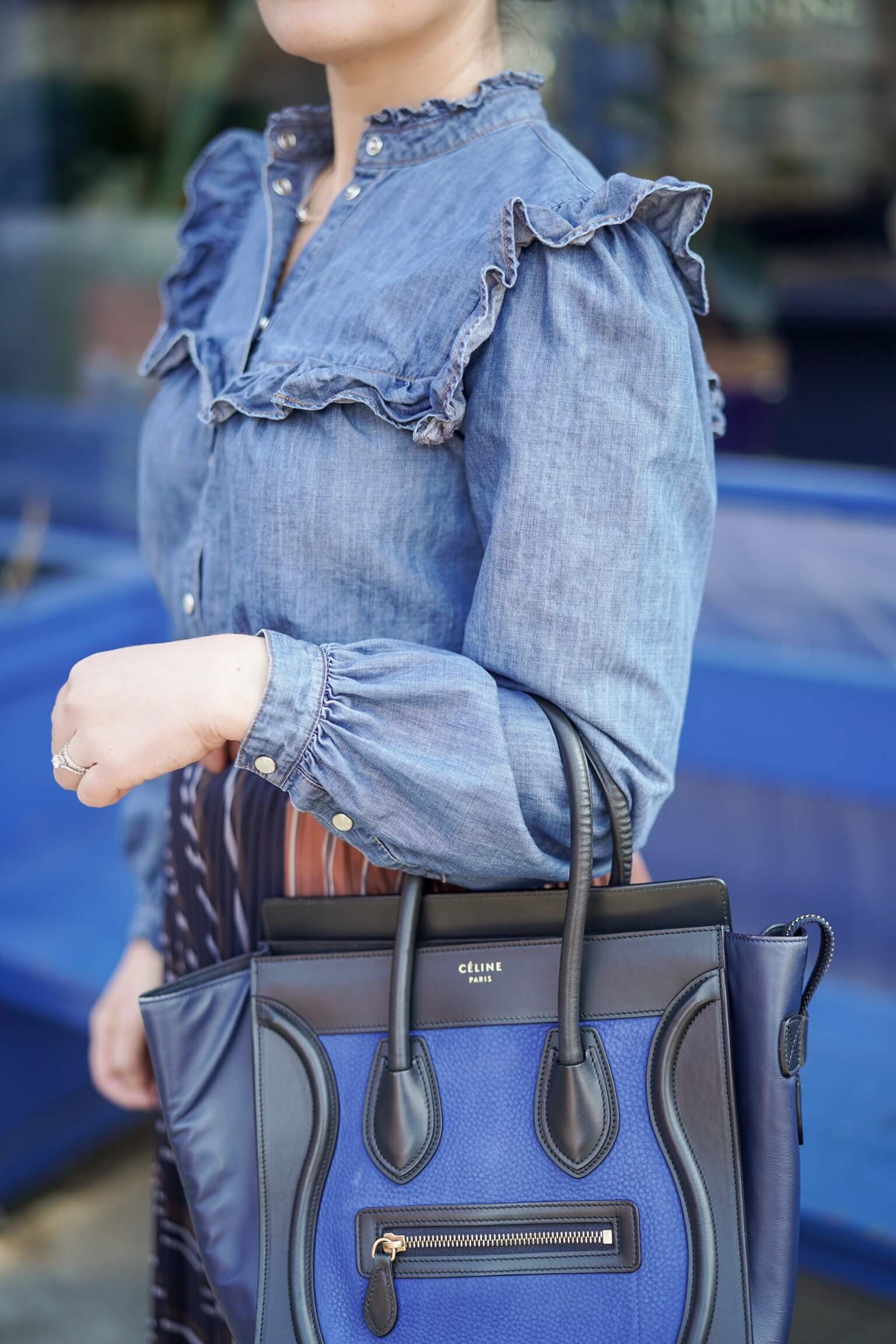 Anthropologie Pleated Skirt Veronica Beard Denim Shirt Coclico Booties Celine Luggage Bag Outfit by Modnitsa Styling